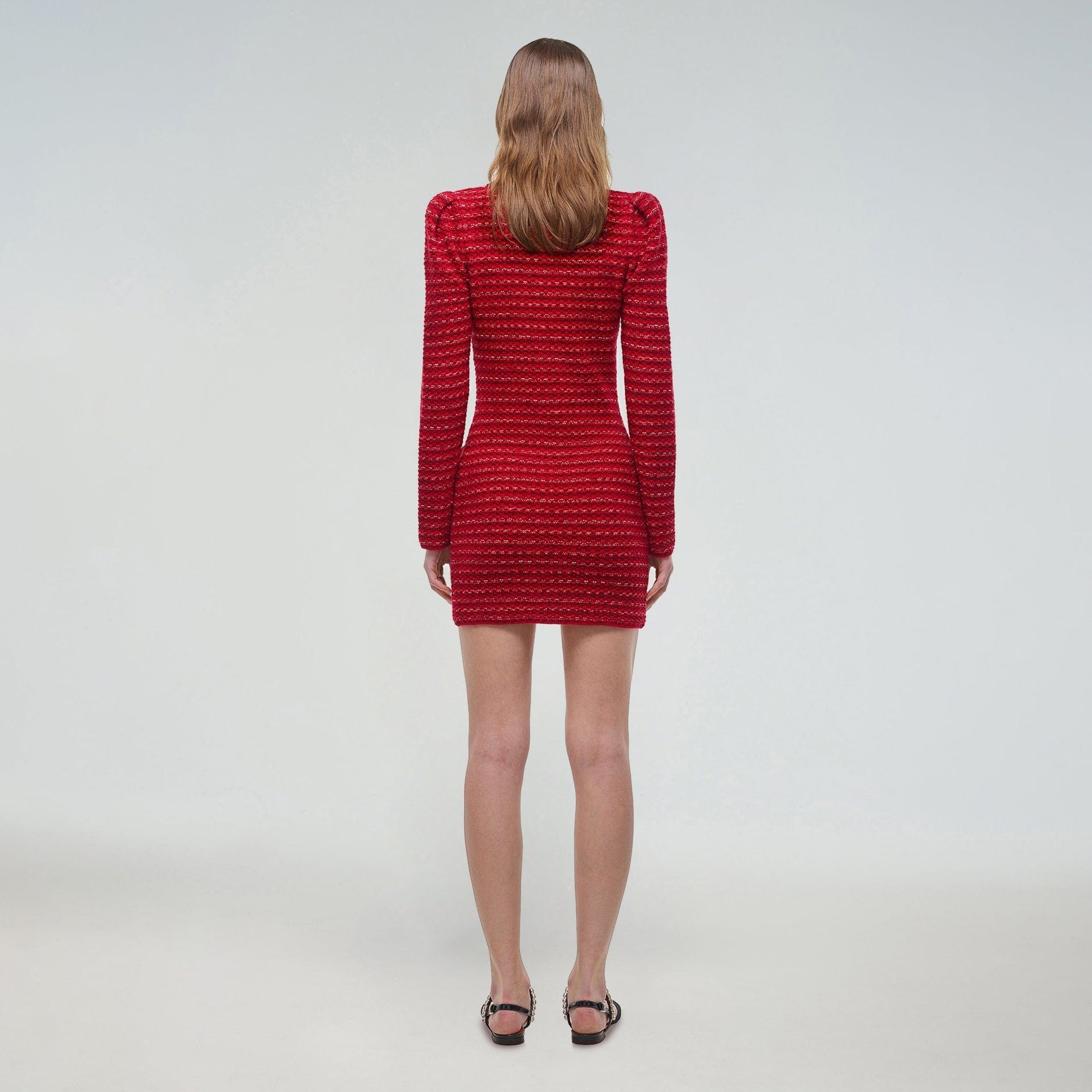 A woman wearing the Red Melange Fitted Knit Mini Dress