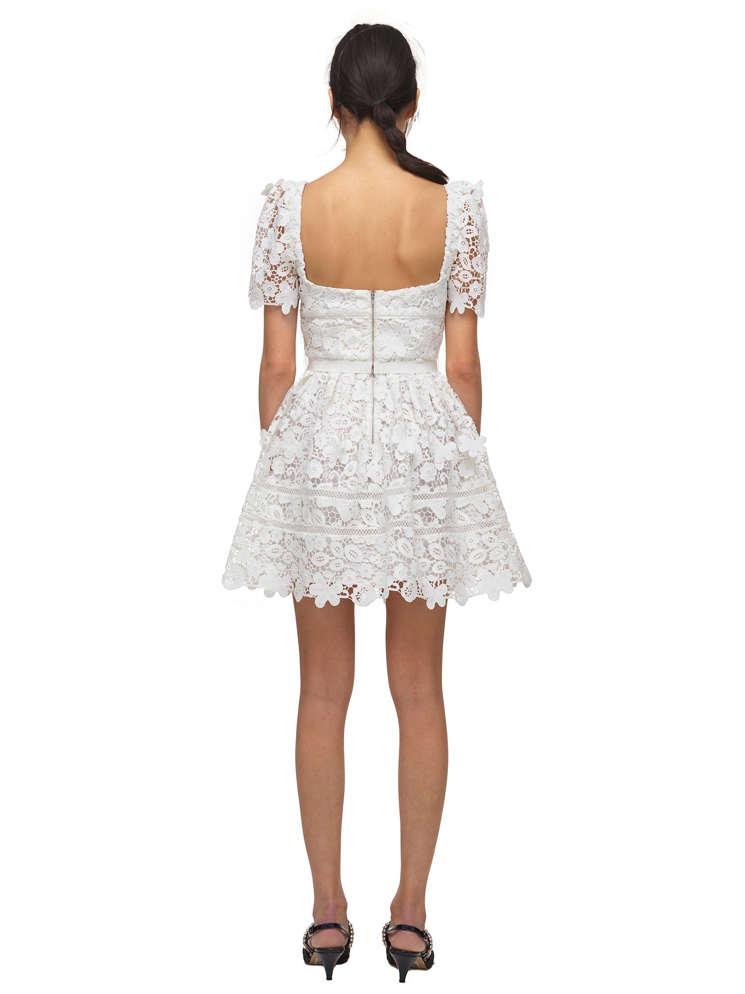 A woman wearing the White Guipure Floral Lace Mini Dress