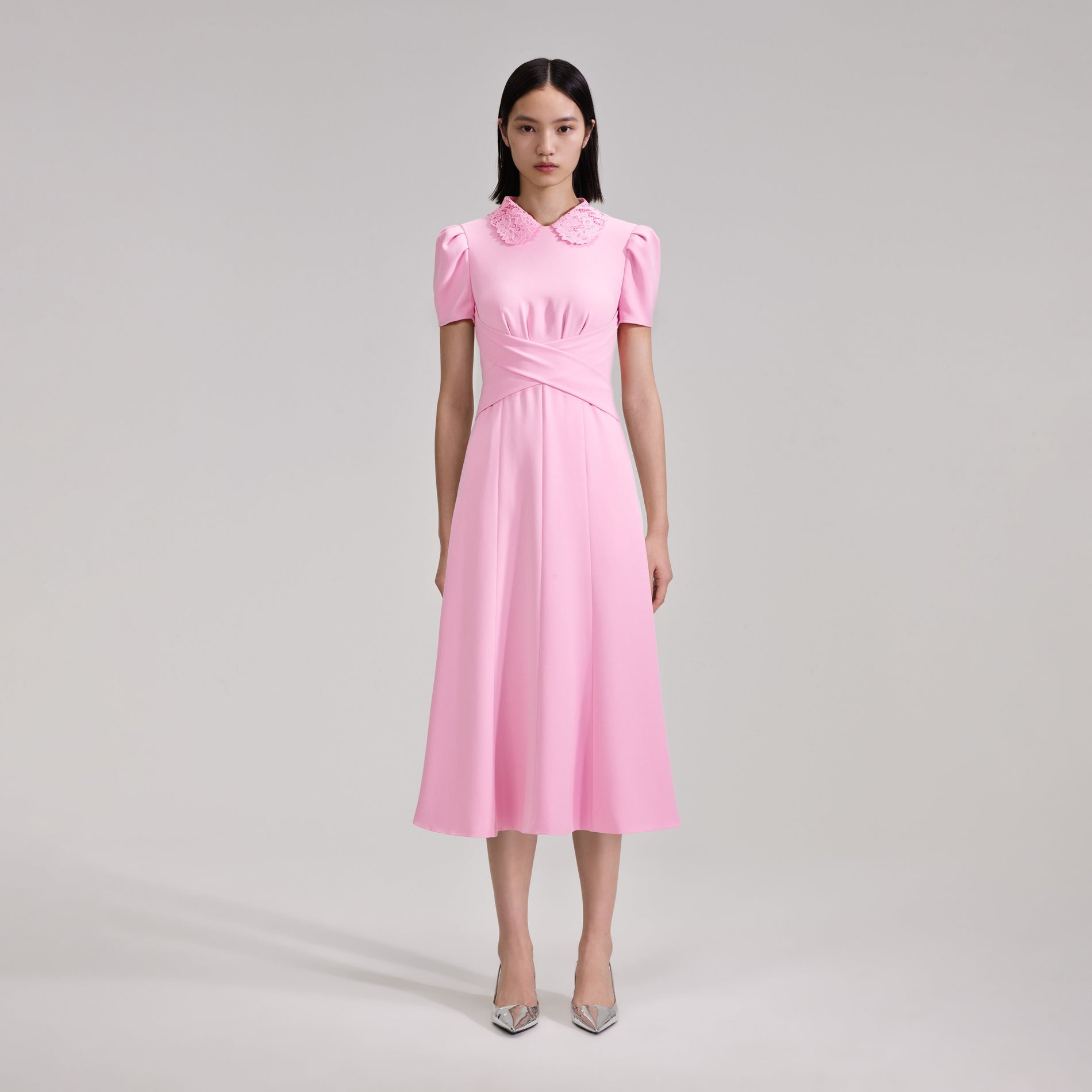 A woman wearing the Pink Heavy Crepe Midi Dress