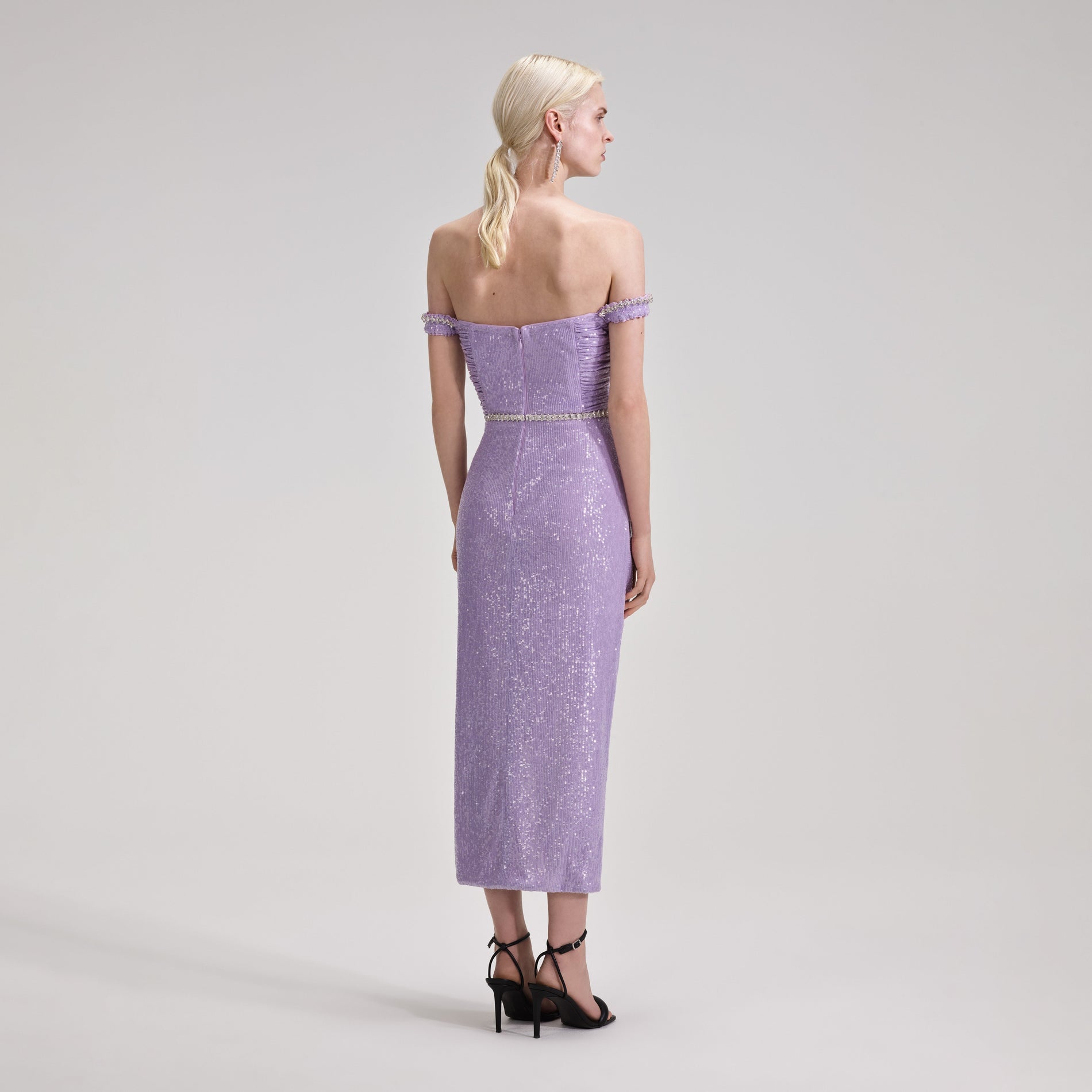 A woman wearing the Lilac Sequin Midi Dress