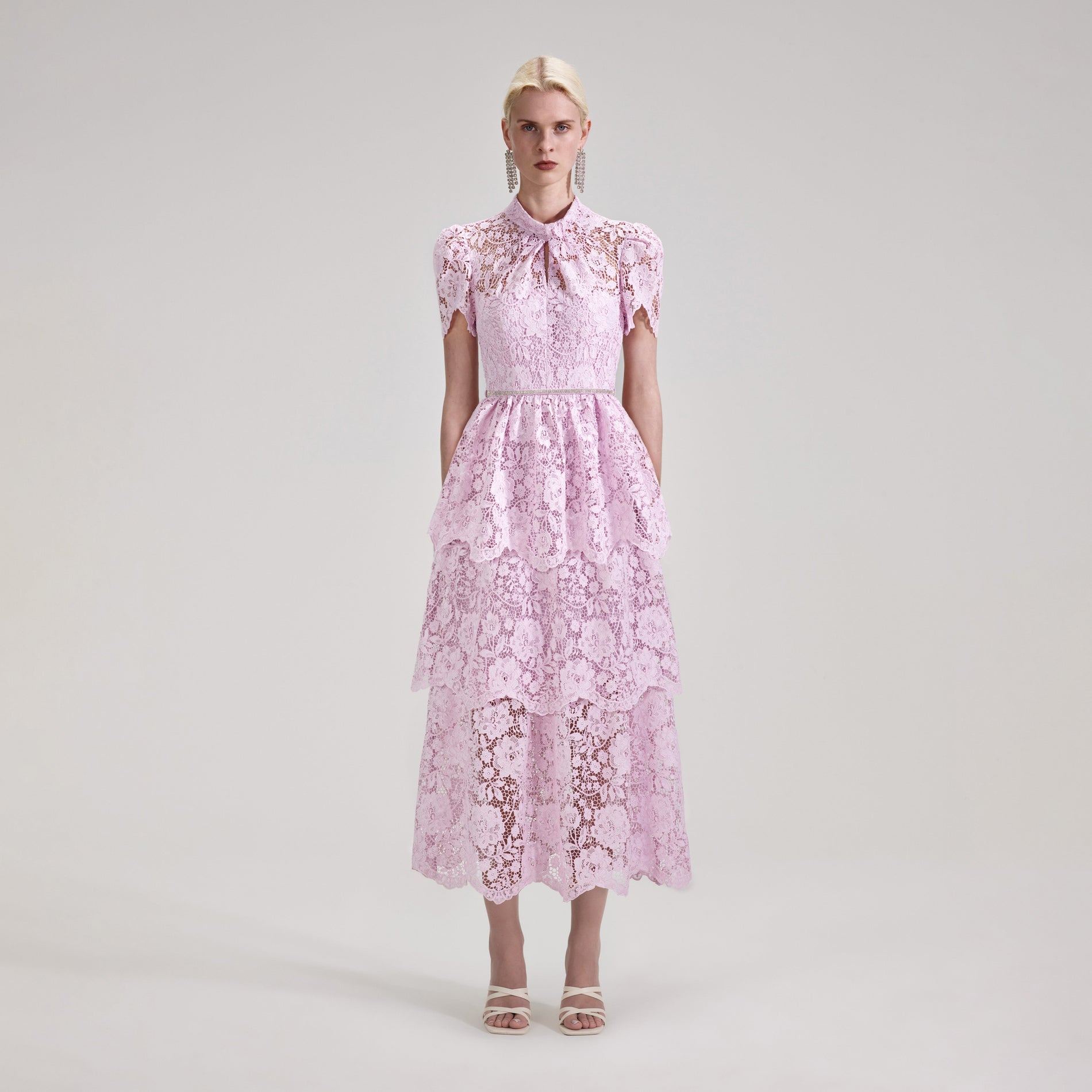 A woman wearing the Pink Cord Lace Tiered Midi Dress