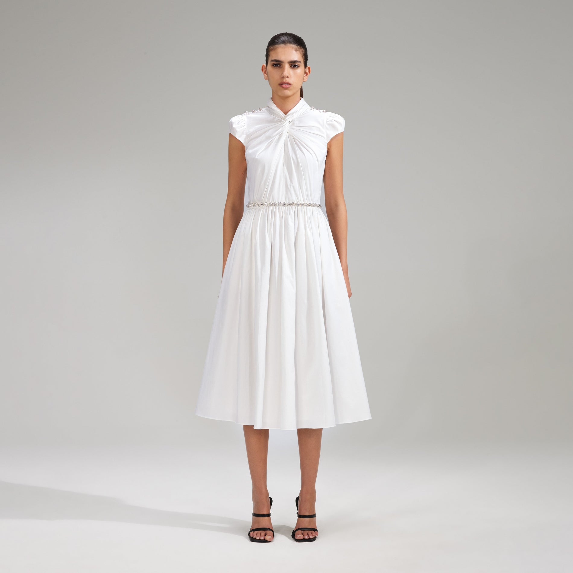 A woman wearing the White Cotton Midi Dress