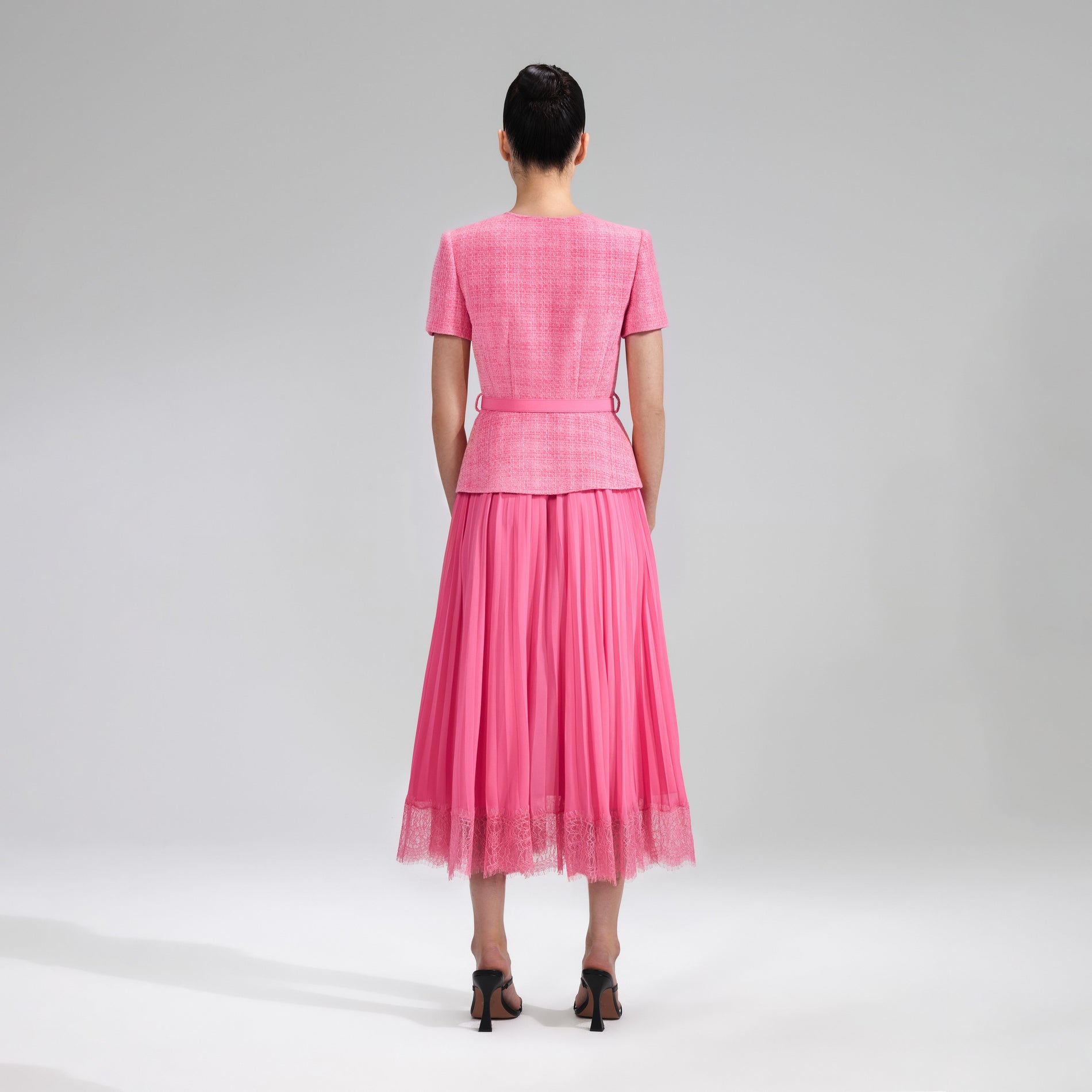 A woman wearing the Pink Boucle Chiffon Midi Dress