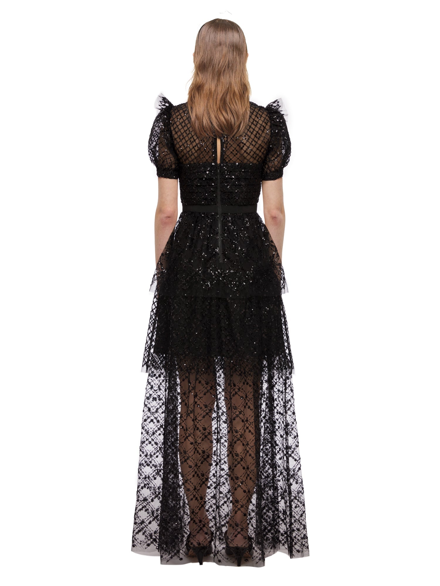 A woman wearing the Black Grid Sequin Tiered Maxi Dress